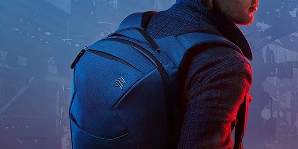 Person wearing a dark backpack with a modern, sleek design.