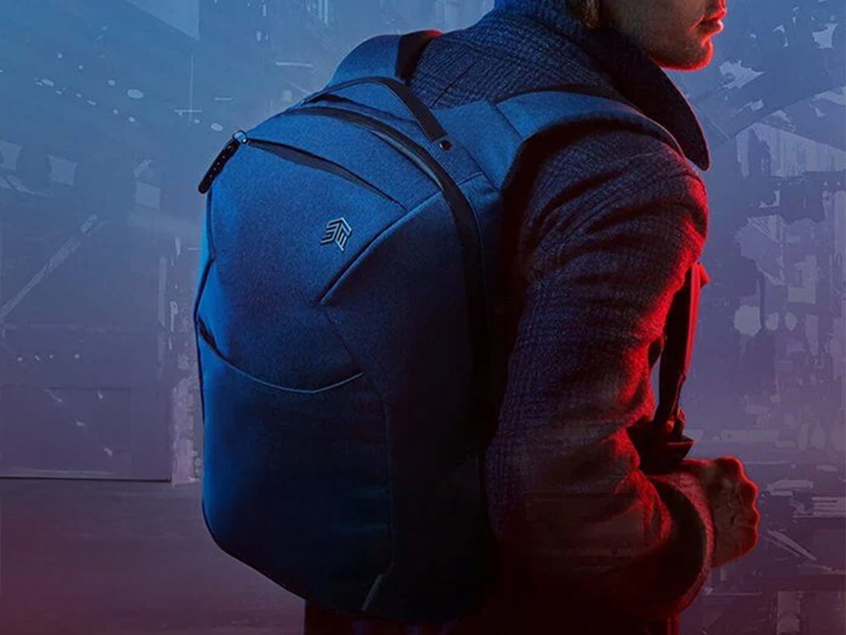 Person wearing a dark backpack with a modern, sleek design.