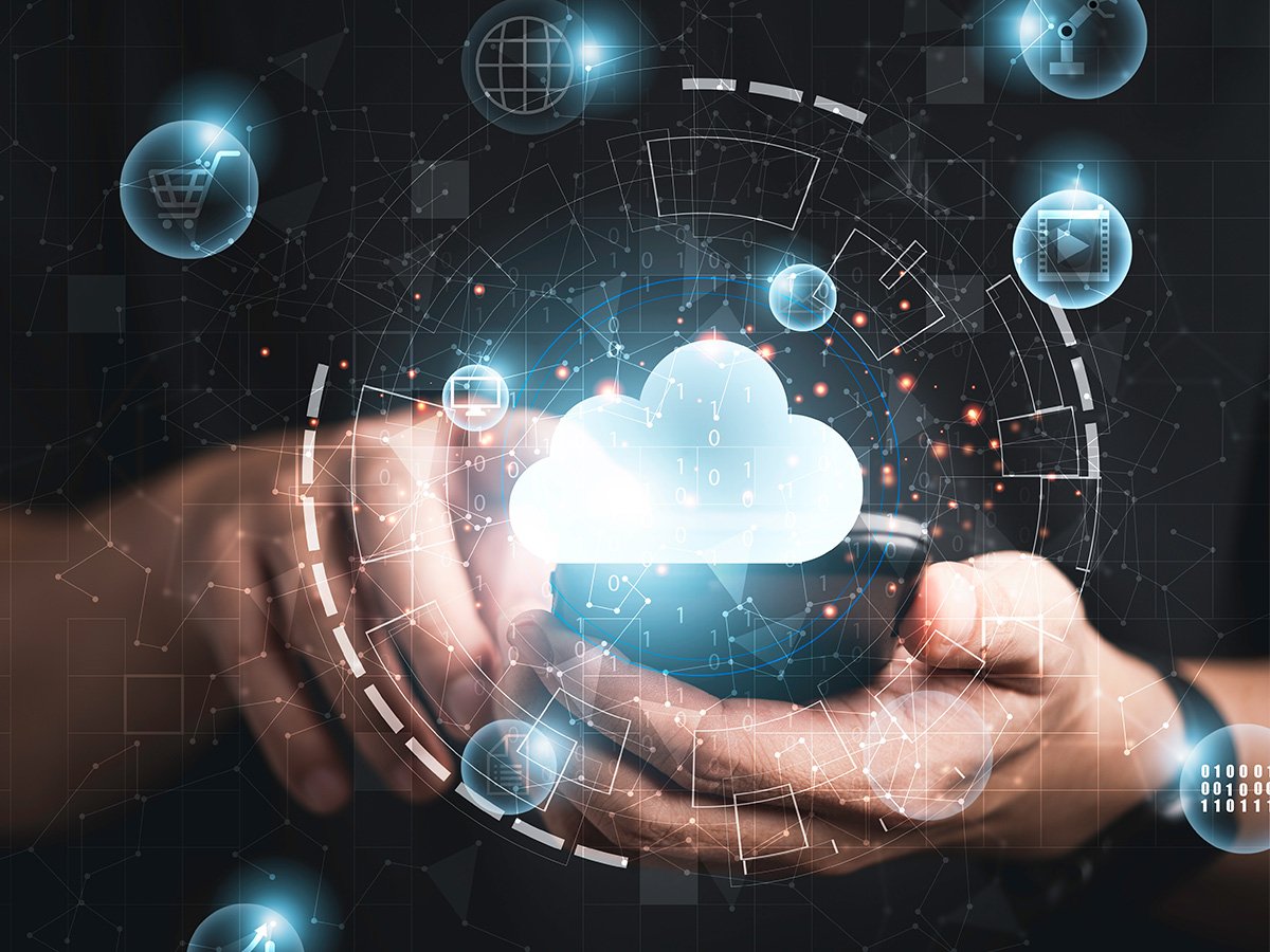 Close up of hands using a mobile phone with cloud and digital graphics overlay