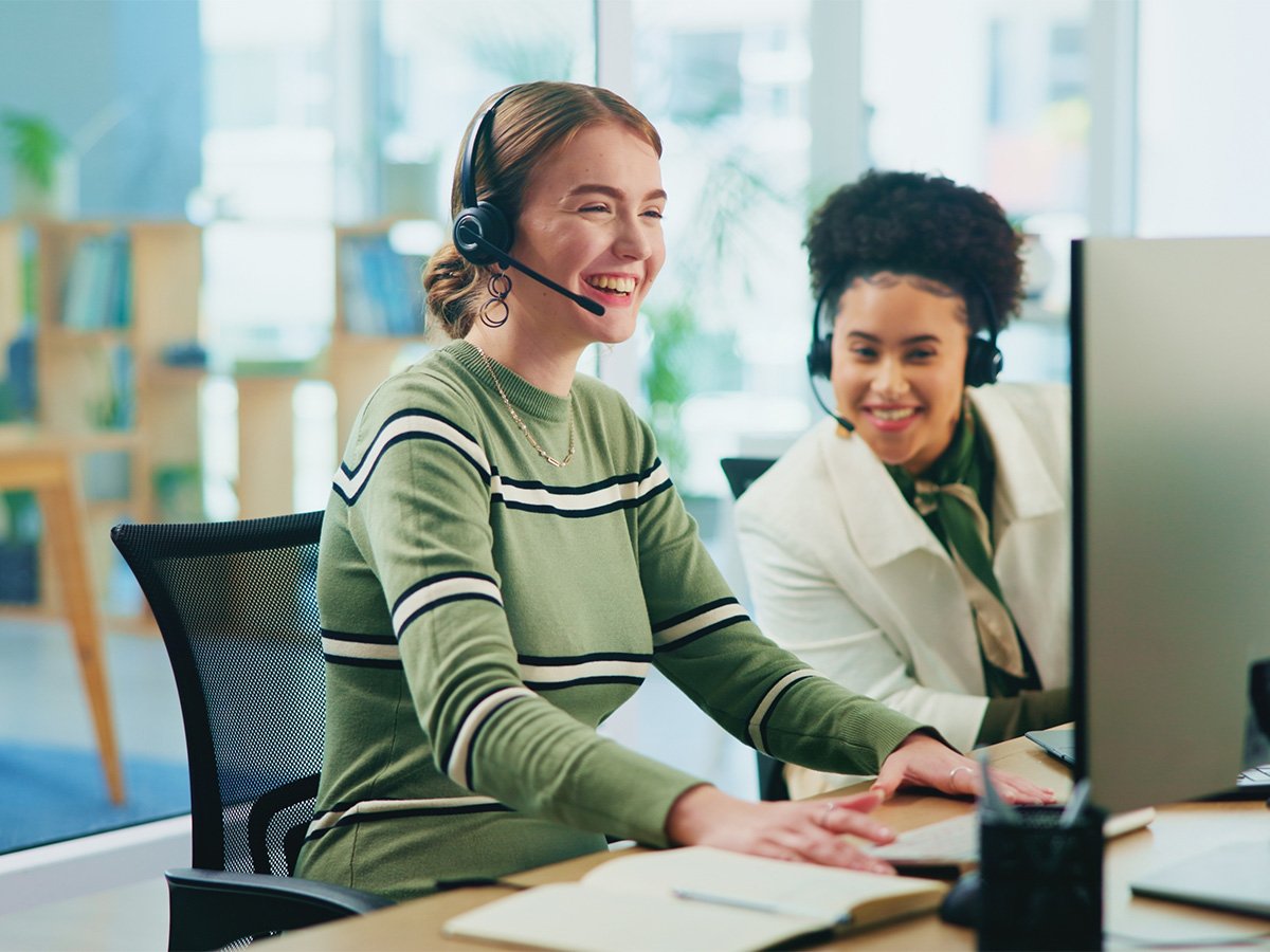 Person wearing a headset working at a desktop