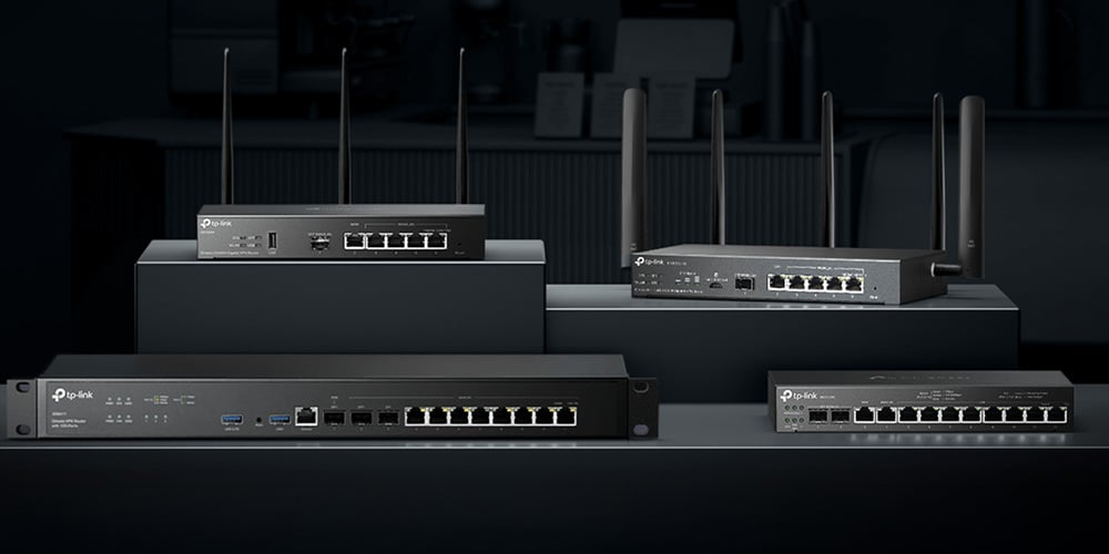 TP‑Link networking routers and switches with multiple antennas displayed on dark stands.