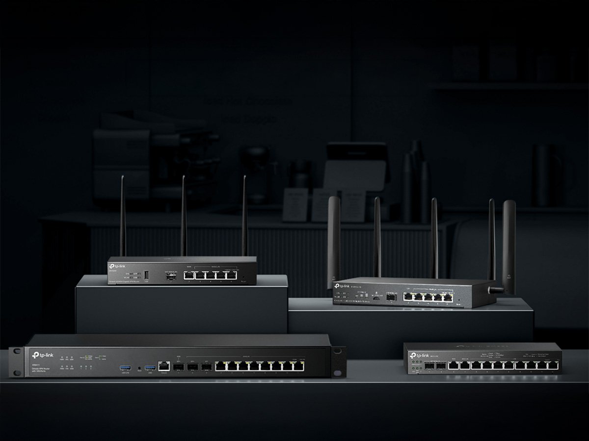 TP‑Link networking routers and switches with multiple antennas displayed on dark stands.