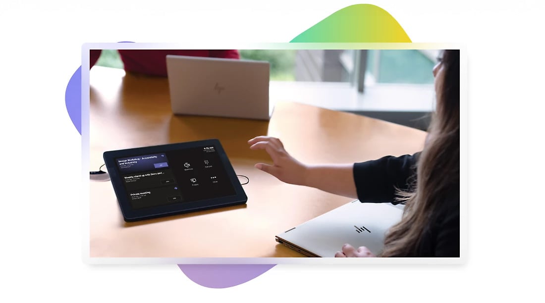 Person using a teams room control panel in a conference room
