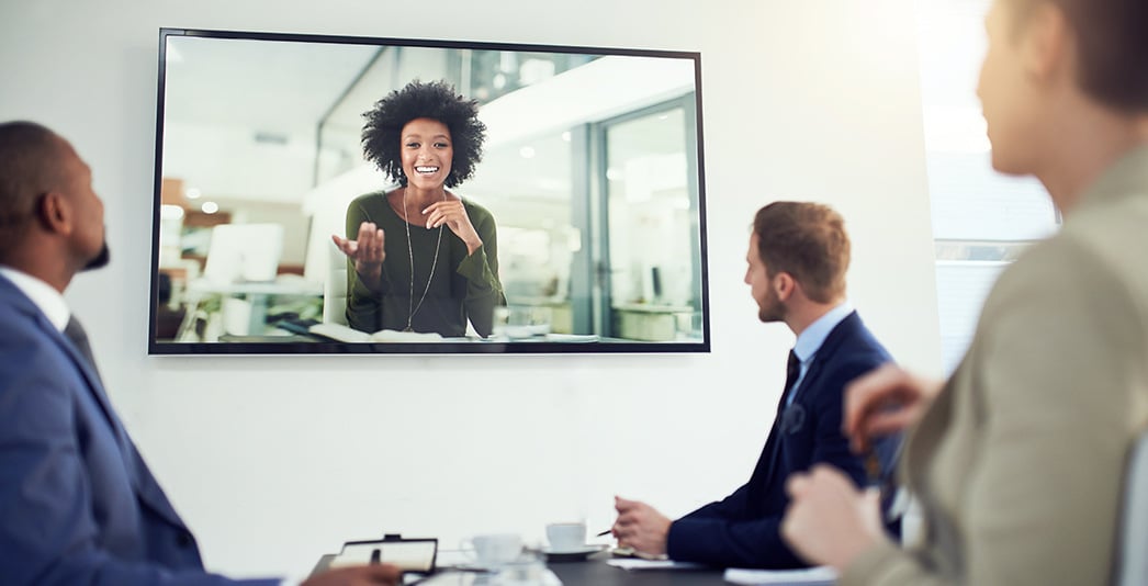 People in a meeting room on a conference call