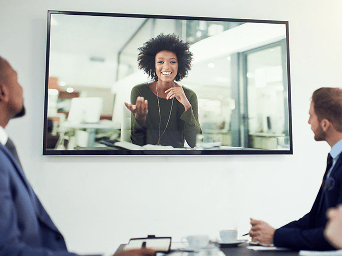 People in a meeting room on a conference call