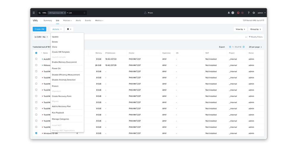 Web-based management dashboard showing a table of virtual machines with status, memory, cluster, and operating system columns, and an actions menu open.