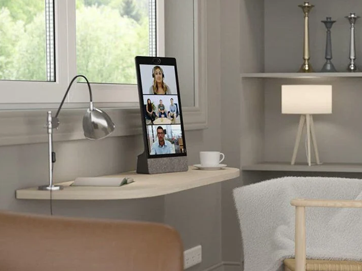 Modern home office with a portrait neat frame displaying a video conference call