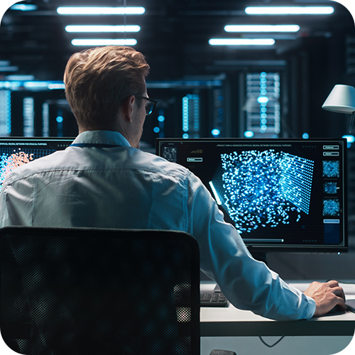 A technician sitting at an IT workstation A technician sitting at an IT workstation