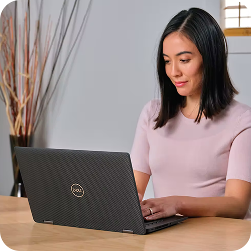 Person working on a laptop at a desk indoors. Person working on a laptop at a desk indoors.